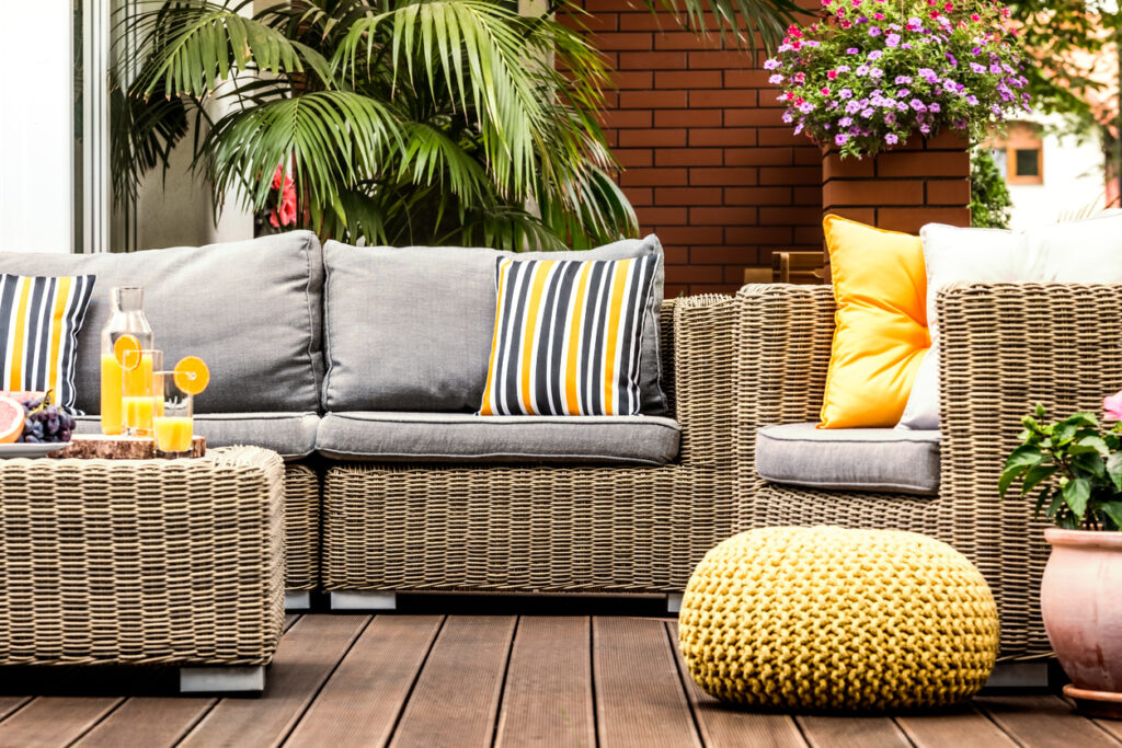 A cozy patio with a wicker furniture set, perfect for relaxing and enjoying the outdoors.