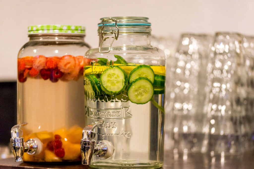 A close-up of a jar filled with cucumbers and water.